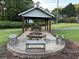Community picnic and fire pit area with table, benches and a shelter at 504 Radford Ct, Woodstock, GA 30188