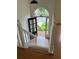 A bright home foyer features hardwood floors, a staircase, and natural light at 504 Radford Ct, Woodstock, GA 30188