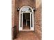 Elegant brick entryway featuring a decorative glass door and view of the staircase at 504 Radford Ct, Woodstock, GA 30188