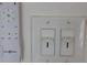 A close up of light switches and a remote control for the ceiling fan at 504 Radford Ct, Woodstock, GA 30188