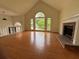 Open living room featuring high ceilings, fireplace, and large windows with lots of natural light at 504 Radford Ct, Woodstock, GA 30188