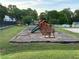 Charming community playground area with play structure and tennis court in view at 504 Radford Ct, Woodstock, GA 30188