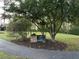 Wellington Manor Recreation Area sign on a grassy lawn beneath a leafy tree and adjacent to a paved walkway at 504 Radford Ct, Woodstock, GA 30188