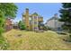 Expansive backyard with mature trees and a well-maintained lawn, perfect for outdoor living and entertainment at 75 Vinings Lake Sw Dr, Mableton, GA 30126