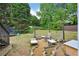 Private backyard featuring a fire pit area with Adirondack chairs, perfect for outdoor gatherings and relaxation at 75 Vinings Lake Sw Dr, Mableton, GA 30126