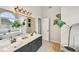 Elegant bathroom featuring double sinks, a soaking tub under an arched window, and modern fixtures at 75 Vinings Lake Sw Dr, Mableton, GA 30126