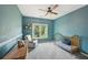 Inviting bedroom features a crib, comfortable seating, and a window with a pleasant view at 75 Vinings Lake Sw Dr, Mableton, GA 30126