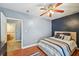 Inviting bedroom showcasing hardwood floors, blue accent wall, and comfortable bed at 75 Vinings Lake Sw Dr, Mableton, GA 30126