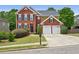 Stunning two-story home with a brick facade, well-kept lawn, and black mailbox at 75 Vinings Lake Sw Dr, Mableton, GA 30126