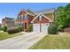 Beautiful brick home with a two-car garage, manicured landscaping, and a driveway at 75 Vinings Lake Sw Dr, Mableton, GA 30126
