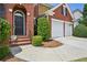Charming two-story brick home featuring a welcoming front door and a two car garage at 75 Vinings Lake Sw Dr, Mableton, GA 30126