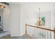Hallway with a decorative chandelier above the stairway at 75 Vinings Lake Sw Dr, Mableton, GA 30126