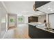 Open-concept living area with tile floors and a large kitchen island, perfect for entertaining and comfortable living at 75 Vinings Lake Sw Dr, Mableton, GA 30126