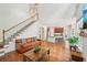 Spacious living room with a fireplace and a large television, and stairs to the second floor at 75 Vinings Lake Sw Dr, Mableton, GA 30126