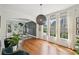 Sun-drenched living room featuring hardwood flooring, modern decor, and a view of the front yard at 75 Vinings Lake Sw Dr, Mableton, GA 30126