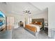 Spacious main bedroom featuring a large bed, tray ceilings and modern décor at 75 Vinings Lake Sw Dr, Mableton, GA 30126