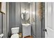 Powder room features a modern sink and golden hardware and wood-look tile flooring at 75 Vinings Lake Sw Dr, Mableton, GA 30126
