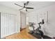 Modern workout room featuring a stationary bike, ceiling fan, and motivational wall art at 75 Vinings Lake Sw Dr, Mableton, GA 30126