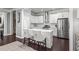 Bright kitchen features stainless appliances, white cabinets, and island with seating and hardwood floors at 1450 Elizabeth Ln, Atlanta, GA 30344