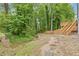 Home featuring wood back deck and backyard with a creek at 285 Camden Park Dr, Lawrenceville, GA 30046