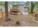Home featuring wood back deck and backyard with a creek and retaining wall at 285 Camden Park Dr, Lawrenceville, GA 30046