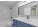 Stylish bathroom with blue vanity, black hardware, and marble-patterned tile at 285 Camden Park Dr, Lawrenceville, GA 30046