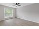 Neutral bedroom featuring hardwood flooring and a large window at 285 Camden Park Dr, Lawrenceville, GA 30046