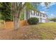 Charming two-story home with a two-car garage, complemented by lush greenery and a wood fence at 285 Camden Park Dr, Lawrenceville, GA 30046