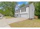 Two-story white brick house with attached garage and black shutters, surrounded by a well-maintained lawn at 285 Camden Park Dr, Lawrenceville, GA 30046