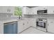 Updated kitchen with white cabinets, stainless steel appliances, and a tiled backsplash, creating a modern look at 285 Camden Park Dr, Lawrenceville, GA 30046
