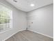 Well-lit laundry room with a large window and gray wood-look flooring at 285 Camden Park Dr, Lawrenceville, GA 30046