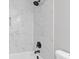 Close-up of shower with marble-patterned tile and black hardware at 285 Camden Park Dr, Lawrenceville, GA 30046