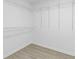 Spacious walk-in closet with white wire shelving and modern wood-look flooring at 285 Camden Park Dr, Lawrenceville, GA 30046