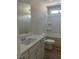 Well-lit bathroom with a vanity, toilet, and shower-tub combination at 3036 Zodiac Ct, Lawrenceville, GA 30044