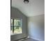 Bright bedroom featuring a large window with views of the outdoors and neutral walls at 3036 Zodiac Ct, Lawrenceville, GA 30044