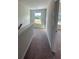 A carpeted hallway featuring natural light from a window overlooking the landscape at 3036 Zodiac Ct, Lawrenceville, GA 30044