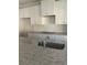 Close-up of a modern kitchen with granite countertops, stainless steel sink, and white cabinets with sleek hardware at 3036 Zodiac Ct, Lawrenceville, GA 30044