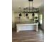 Beautiful kitchen with a large center island, white cabinetry, stainless steel appliances, and modern pendant lighting at 3036 Zodiac Ct, Lawrenceville, GA 30044