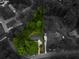 Aerial view of a property with a lush green yard, surrounded by mature trees, in a quiet neighborhood at 3560 Emily Way, Atlanta, GA 30349