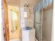 Bathroom with white tile, vanity and shower stall next to window at 3560 Emily Way, Atlanta, GA 30349