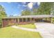 Charming brick home with well-manicured front yard and a covered carport at 3560 Emily Way, Atlanta, GA 30349