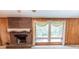 Cozy living room with a brick fireplace, wood paneling and natural light at 3560 Emily Way, Atlanta, GA 30349
