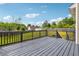 A back deck with a view to the spacious green backyard with fence and storage shed at 3715 Frankie Wade Ln, Loganville, GA 30052