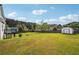 Large backyard featuring a well-maintained lawn and a storage shed at 3715 Frankie Wade Ln, Loganville, GA 30052