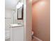 Bathroom featuring tiled accent wall, white vanity with granite countertop and framed mirror at 3715 Frankie Wade Ln, Loganville, GA 30052