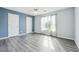 Bedroom with blue accent wall, two closets and luxury vinyl plank flooring at 3715 Frankie Wade Ln, Loganville, GA 30052