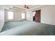 Large main bedroom featuring a trey ceiling, ceiling fan, two windows, and a barn door at 3715 Frankie Wade Ln, Loganville, GA 30052