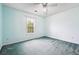 Bedroom with large window providing ample natural light and a ceiling fan at 3715 Frankie Wade Ln, Loganville, GA 30052