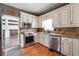 Well-lit kitchen featuring white cabinets, granite countertops, and stainless steel appliances at 3715 Frankie Wade Ln, Loganville, GA 30052
