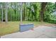 Beautiful backyard featuring large trees, mature landscaping, and a concrete patio area at 140 Larose Se Cir, Marietta, GA 30060